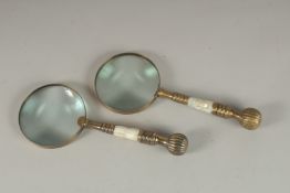 A PAIR OF MAGNIFYING GLASSES with mother-of-pearl and bone handles.