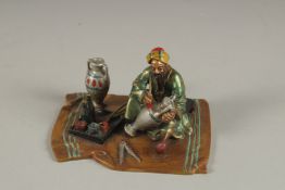 A PAINTED COLD CAST GROUP, a man painting a vase. 3.5ins x 3ins.