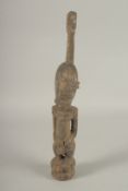 A CARVED WOOD TRIBAL FIGURE OF A STANDING MALE. 40cms high.