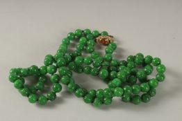 A SUPERB JADE BEAD NECKLACE with diamond, gold and citrine clasp.