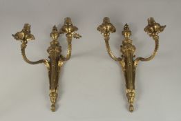 A PAIR OF CLASSICAL GILT BRONZE TWIN-BRANCH WALL LIGHTS. 38cms high.