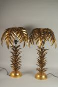 A PAIR OF GILT METAL PALM TREE LAMPS. 29ins high.