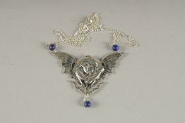 AN ART NOUVEAU SILVER AND LAPIS PENDANT.
