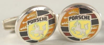 A PAIR OF STERLING SILVER AND ENAMEL PORSCHE EMBLEM CUFFLINKS.