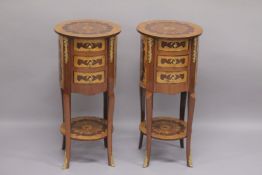 A PAIR OF LOUIS XVITH STYLE INLAID CIRCULAR BEDSIDE CUPBOARDS with three drawers and an under-