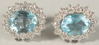 A PAIR OF 18CT WHITE GOLD, AQUAMARINE AND DIAMOND DUAL CLUSTER EAR STUDS, approx. 14mms x 12mms.