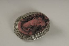 AN OVAL CAMEO LAVA BROOCH.