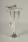 A SILVER-PLATED BAR TOOL SET.