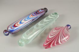 THREE PIECES OF NAILSEA GLASSWARE, to include two rolling pins and a flask. Rolling Pins: 35cms