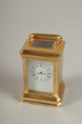 A MINIATURE BRASS CARRIAGE CLOCK. 3.5ins high.