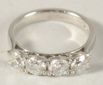 A PLATINUM AND FOUR STONE DIAMOND RING.