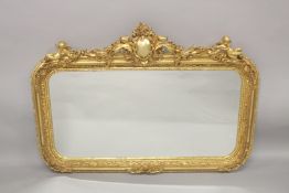 A GOOD LOUIS XVITH STYLE GILTWOOD OVERMANTLE MIRROR with shaped top with cupids and garlands.
