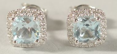 A PAIR OF 18CT WHITE GOLD, BLUE TOPAZ AND DIAMOND CUSHION SHAPE EAR STUDS.