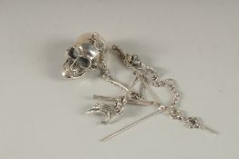 A SILVER SKULL on a chain.