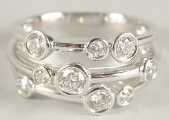 AN 18CT WHITE GOLD AND DIAMOND BUBBLE RING.