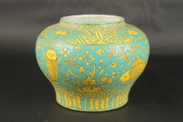 A CHINESE TURQUOISE GLAZE PORCELAIN JAR, with fish and algae designs. 20cms high.