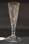 A GEORGIAN WINE GLASS with plain bowl and facet cut stem.