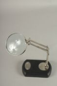 A MAGNIFYING GLASS on a stand.