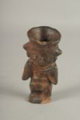A SMALL SOUTH AMERICAN POTTERY FIGURE. 15cms high.