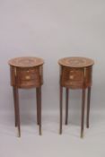 A PAIR OF LOUIS XVITH STYLE INLAID CIRCULAR BEDSIDE CUPBOARDS with three drawers and an under-