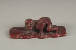 A HARDWOOD FIGURE OF A Leaf. Signed. 4ins high.