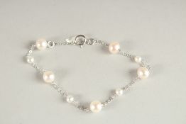 AN 18CT WHITE GOLD AND PEARL BRACELET.