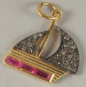 A SMALL DIAMOND AND RUBY BOAT CHARM.