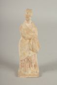 A TERRACOTTA ANTIQUE OF A STANDING LADY. 7ins high.