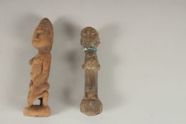 TWO SMALL ANTIQUE CARVED WOOD TRIBAL FIGURES / DOLLS. 12cms and 14cms high.