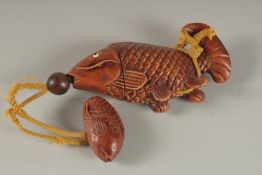 A CARVED HARDWOOD FISH INRO. 4.5ins long.