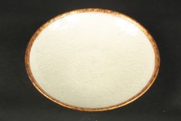 A CHINESE DING WARE BOWL. 20cms diameter.
