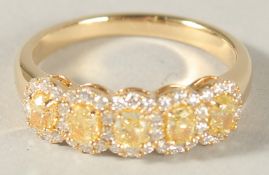AN 18CT YELLOW GOLD AND NATURAL YELLOW AND WHITE DIAMOND RING.
