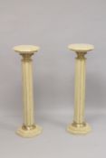A GOOD PAIR OF BEIGE MARBLE TOP COLUMNS. 39ins high.