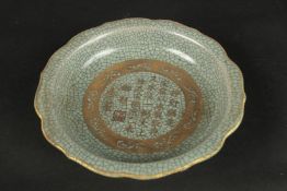 A CELADON CRACKLE GLAZE PETAL FORM DISH, with gilt characters. 19cms wide.