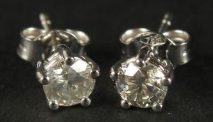 A CERTIFICATED PAIR OF 18CT WHITE GOLD UNUSUAL 5 CLAW-SET RBC DIAMOND SOLITAIRE STUDS, boxed.