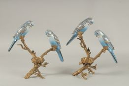 A PAIR OF CONTINENTAL PORCELAIN AND GILT METAL BUDGIE CANDLESTICKS ON STANDS.