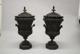 A GOOD PAIR OF 18TH CENTURY IRISH DESIGN MAHOGANY TWO-HANDLED URNS AND COVERS, carved with cupids,