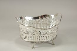 A SILVER-PLATED BREAD BASKET.