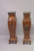 A PAIR OF INLAID PEDESTALS with square marble tops. 44ins high.