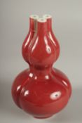 A CHINESE IRON RED GLAZE TULIP VASE, the base with character mark, 20cm high.