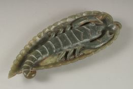 A GREEN SOAPSTONE CARVING, of leaf form with large insect to centre, 26cm long.