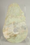 A LARGE CHINESE JADE DISK, with incised characters, 33.5cm x 21cm.