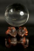 A VERY FINE JAPANESE CARVED WOOD OKIMONO OF THREE WISE MONKEYS WITH GLASS BALL, in the manner of