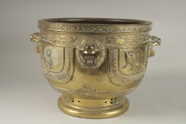 A LARGE AND IMPRESSIVE GILT BRONZE JARDINIERE, with raised lion heads and panels depicting