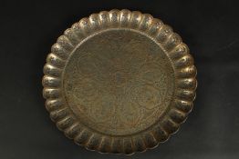 A FINE 18TH CENTURY MUGHAL INDIAN TINNED BRASS CHARGER, signed to the reverse, 34cm wide.