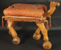 A MID 20TH CENTURY CARVED WOOD CAMEL SEAT, with leather top.