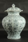 A VERY LARGE CHINESE BLUE AND WHITE PORCELAIN FLORAL URN AND COVER, 55cm high.