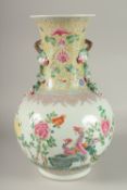A LARGE CHINESE FAMILLE ROSE PORCELAIN VASE, painted with exotic birds and flora, with moulded
