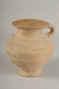 A 10TH CENTURY MIDDLE EASTERN ISLAMIC UNGLAZED POTTERY JUG, with carved calligraphy and animals,