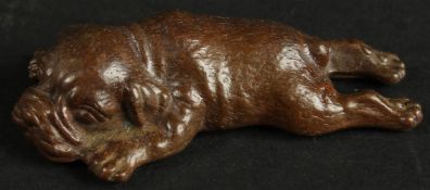 A BRONZE OKIMONO OF A SLEEPING DOG.